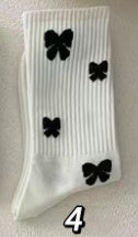 Charming Black Strawberry Mid-Calf Socks with Playful Japanese Butterfly Whirl