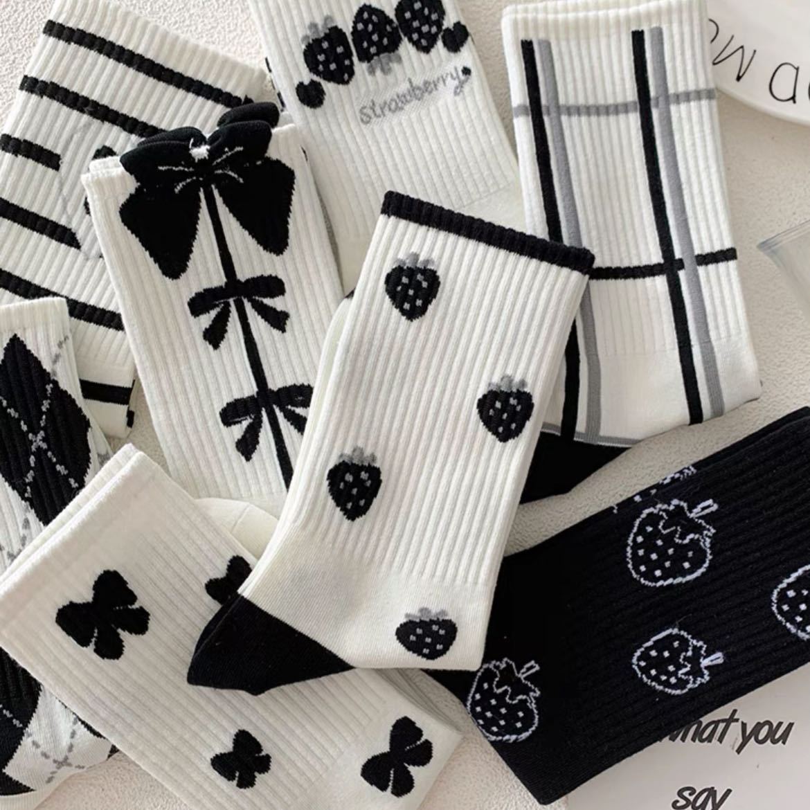 Charming Black Strawberry Mid-Calf Socks with Playful Japanese Butterfly Whirl