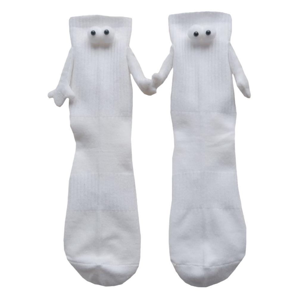 3D eye socks with magnetic hands at the end of little arms are holding hands. The background is white. 